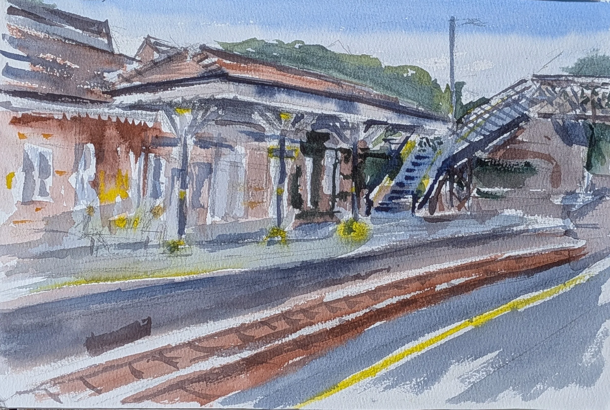 Ink and watercolour: A platform, tracks and footbridge at Maghull Station, in loose watercolour washes.