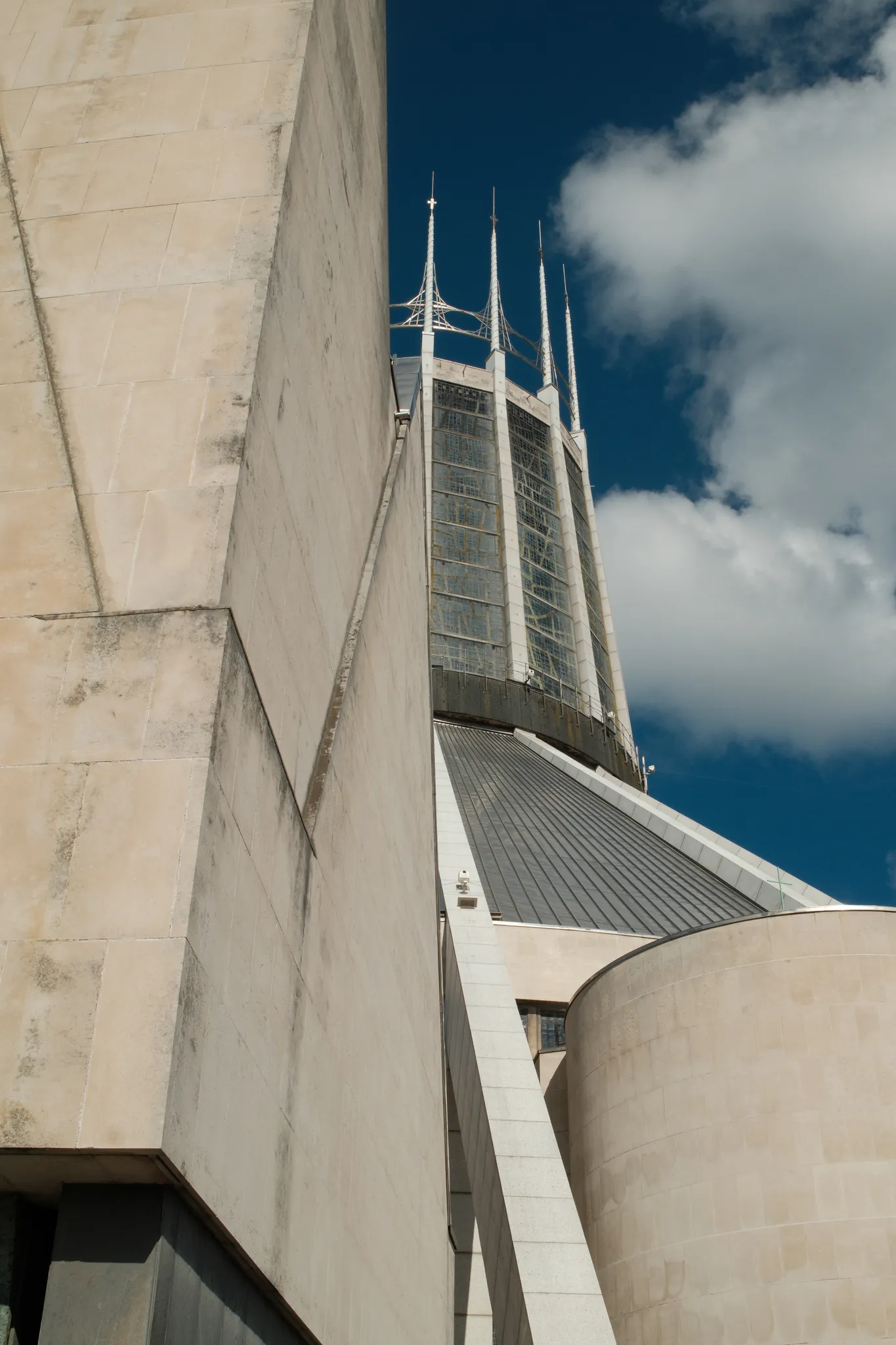 The crown of Liverpool Metropolitan Cathedral rises between curved concrete forms.