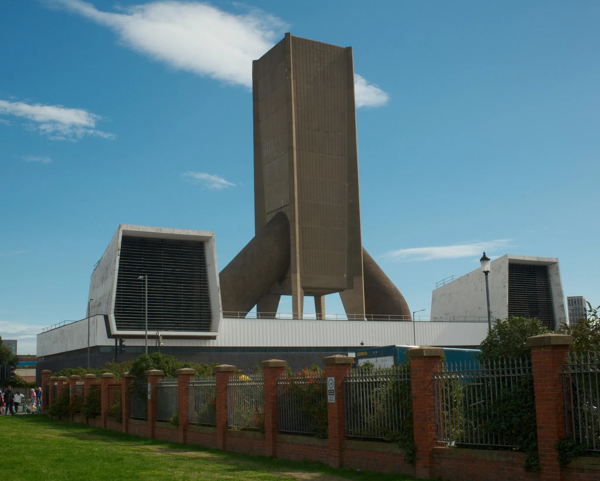 The angular Kingsway Tunnel ventilation tower rises above Waterloo Road under a blue sky.