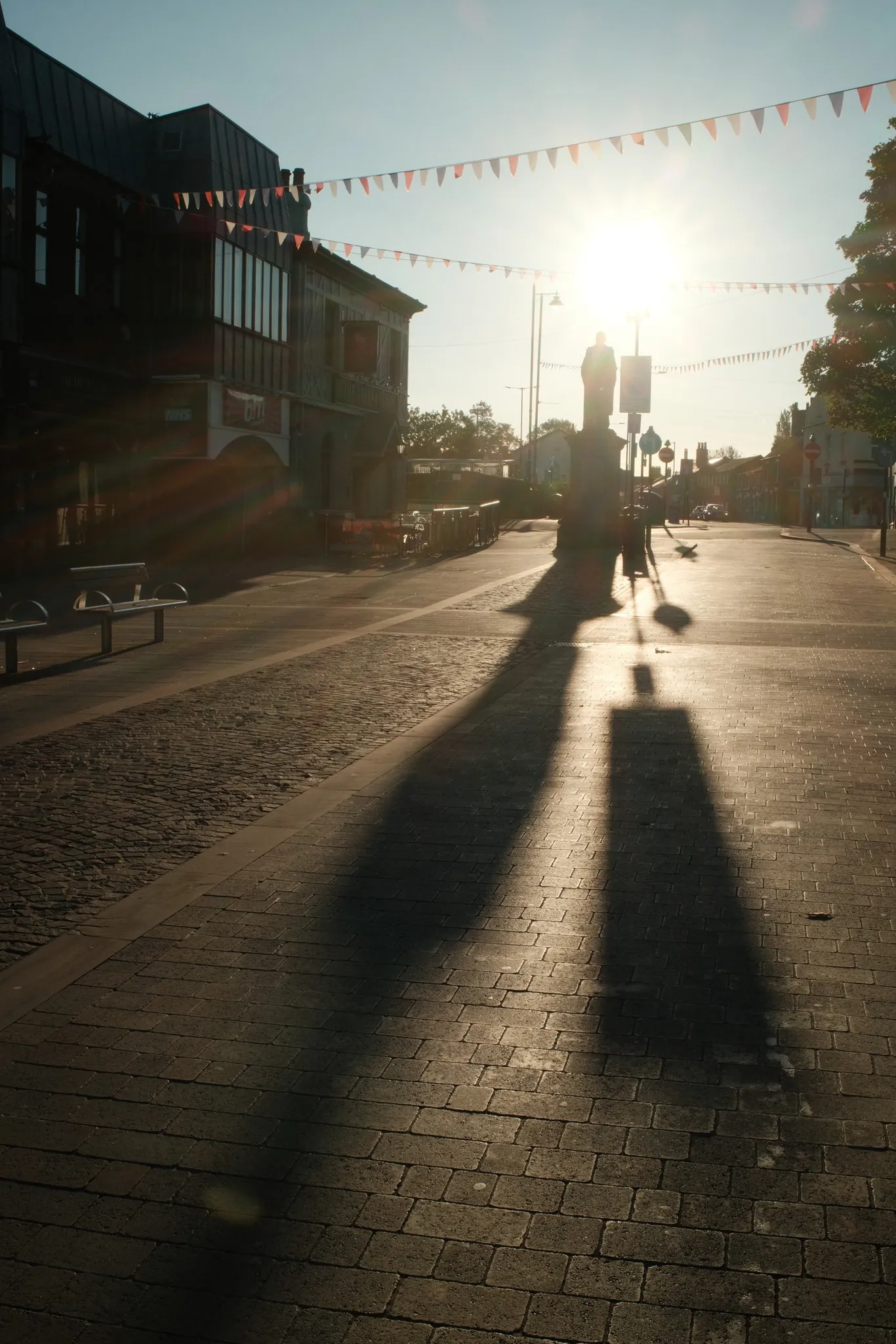 Long shadows stretch across Moor Street beside Ormskirk’s Disraeli statue.