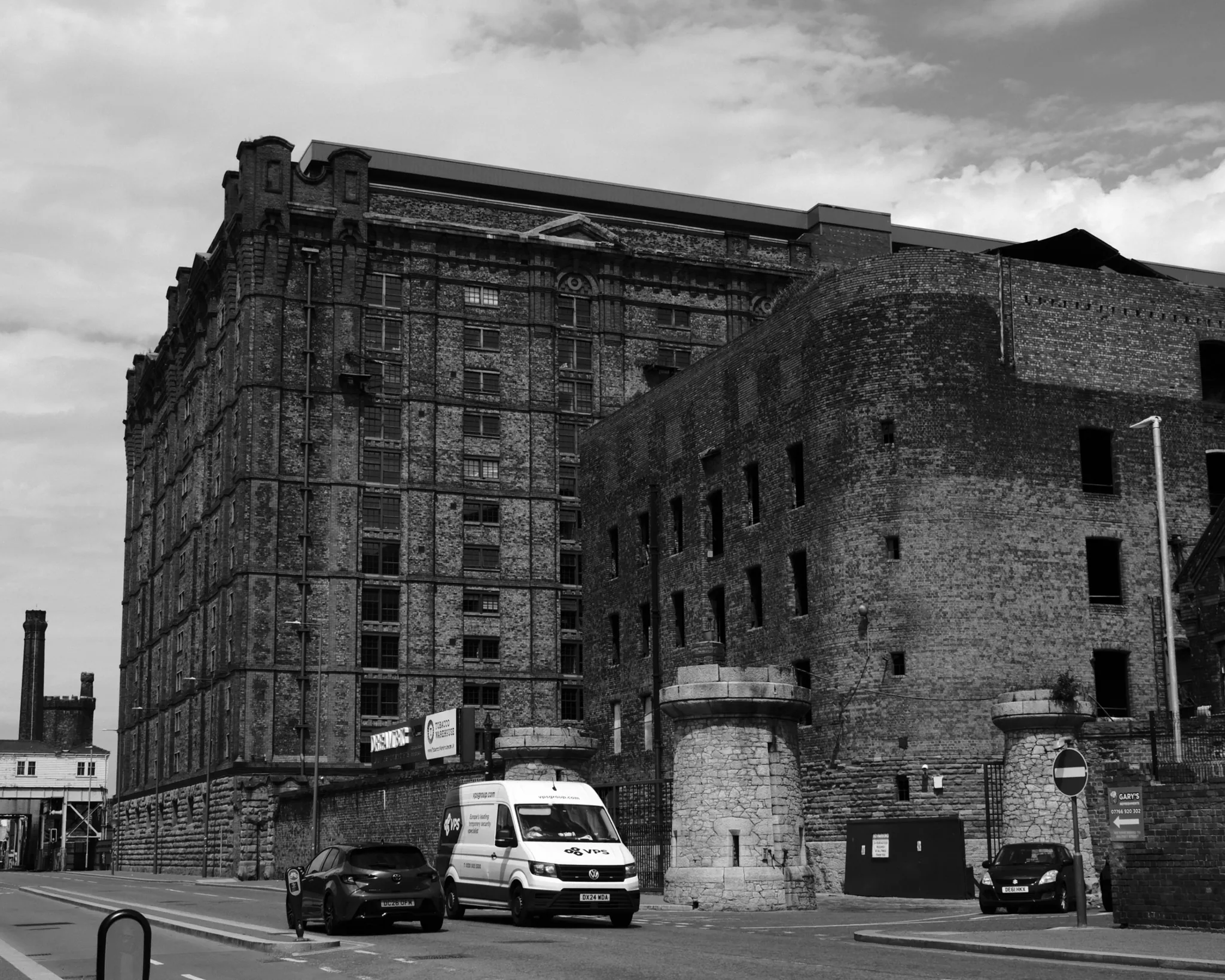 The vast brick Tobacco Warehouse rises above older dock buildings at Stanley Dock.