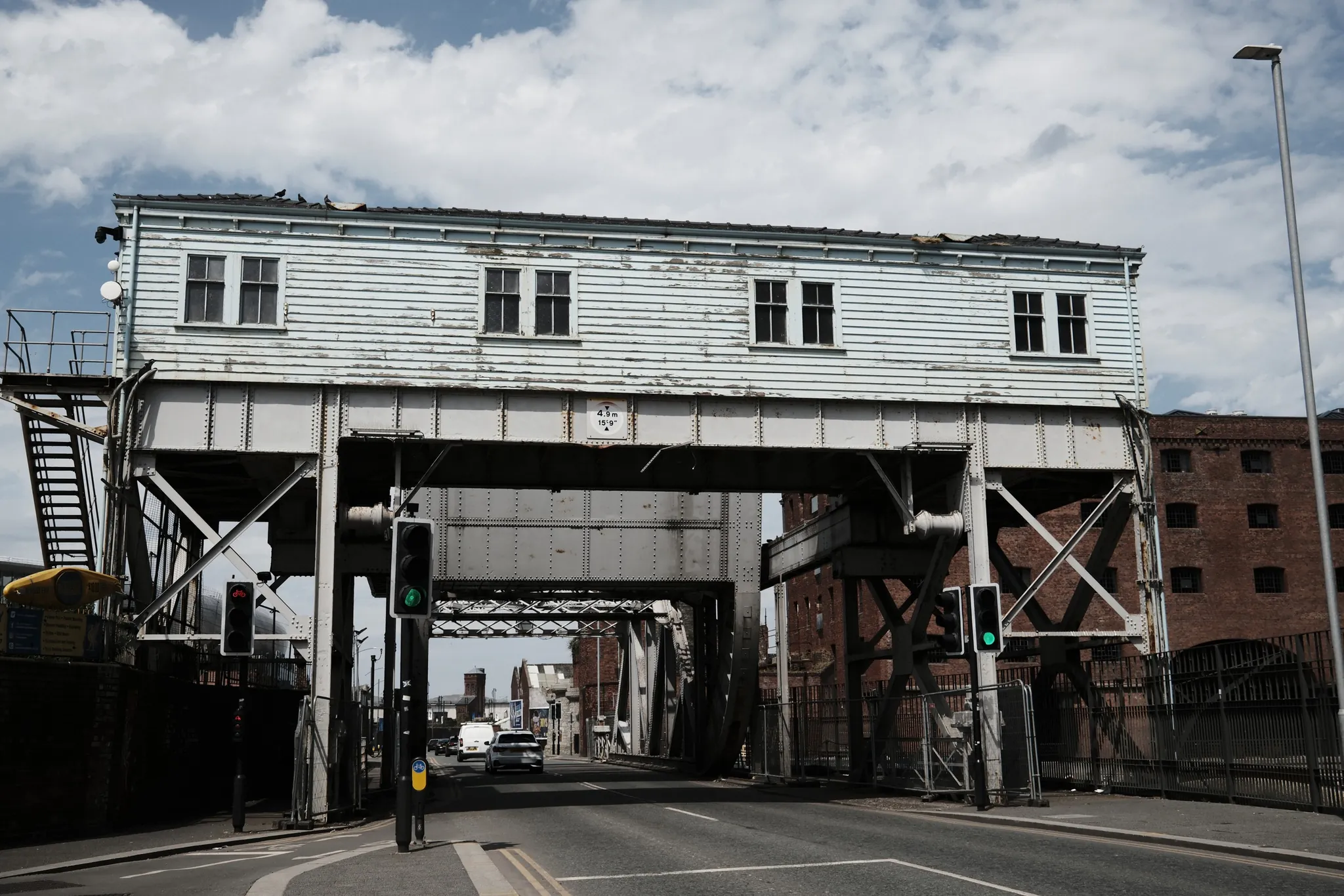 The overhead structure of the Regent Road bascule bridge spans the road beside Stanley Dock.