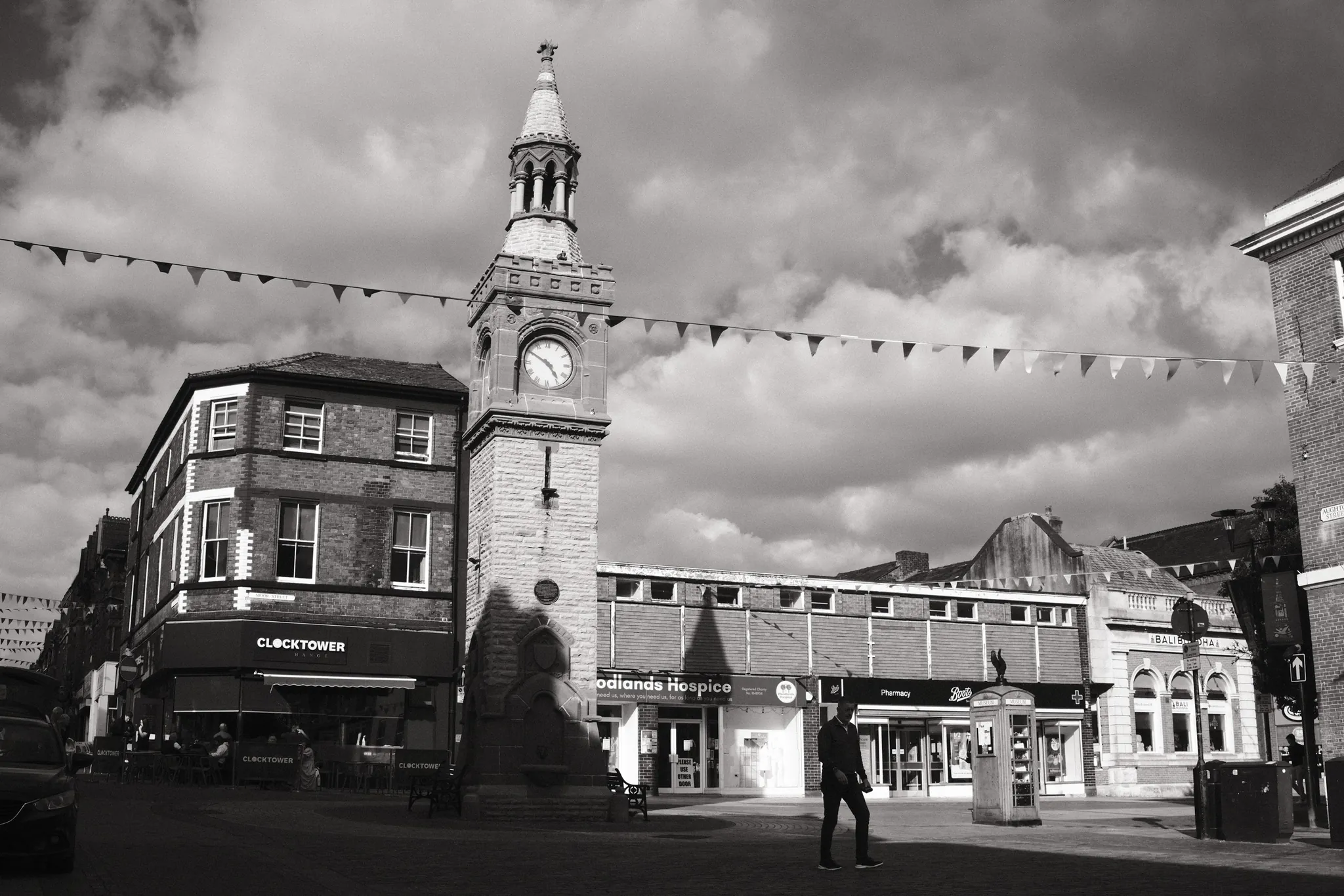 Bunting crosses the sky around Ormskirk Clock Tower and the surrounding shopfronts.