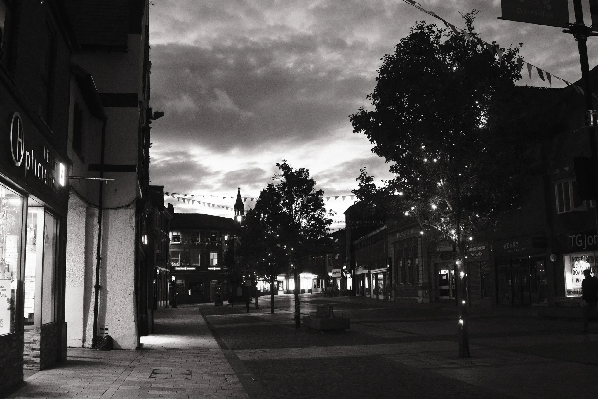 Ormskirk’s Moor Street leads towards the Clock Tower beneath an evening sky.