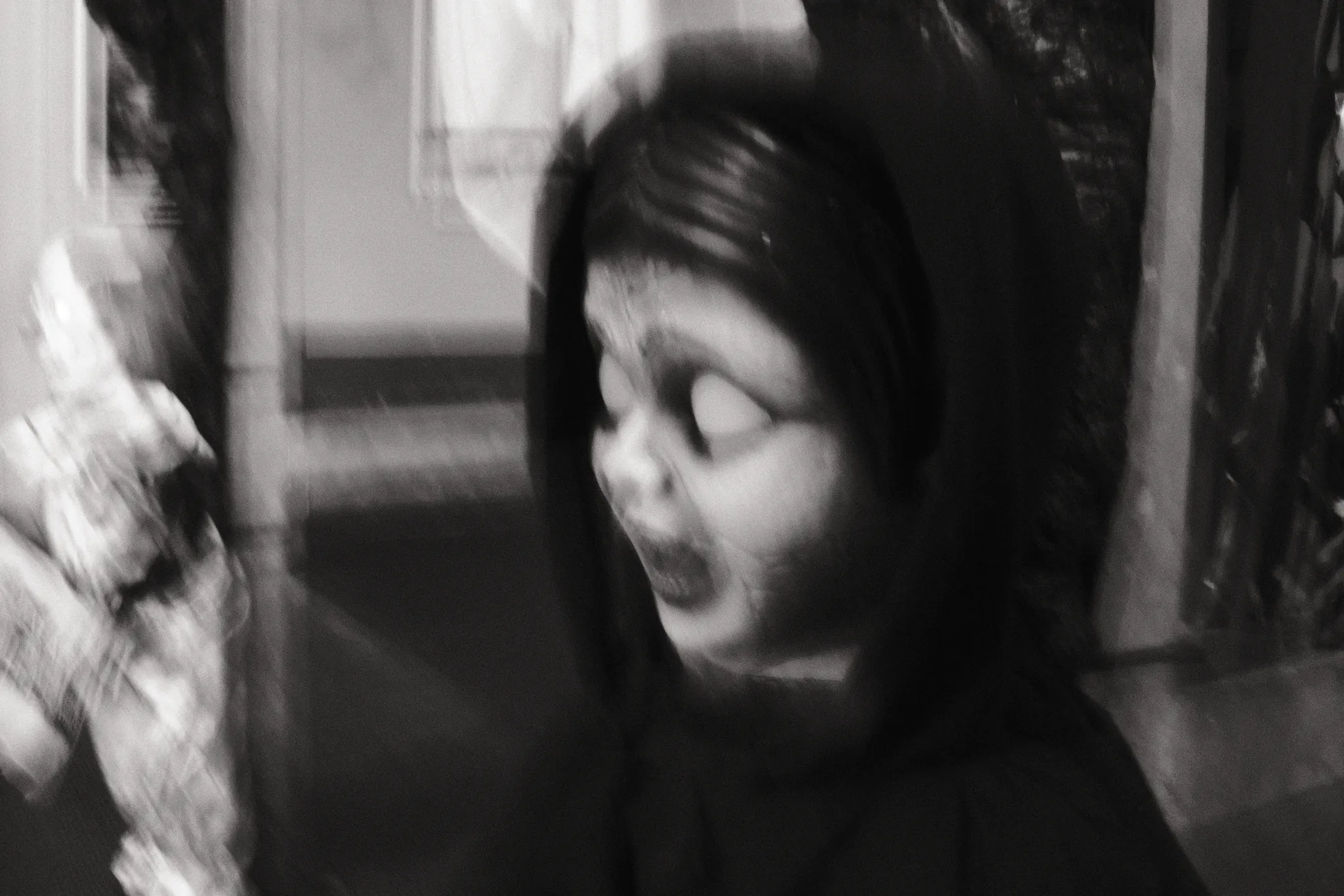 A soft-focus Halloween effigy with pale eyes and dark hair, photographed in black and white.