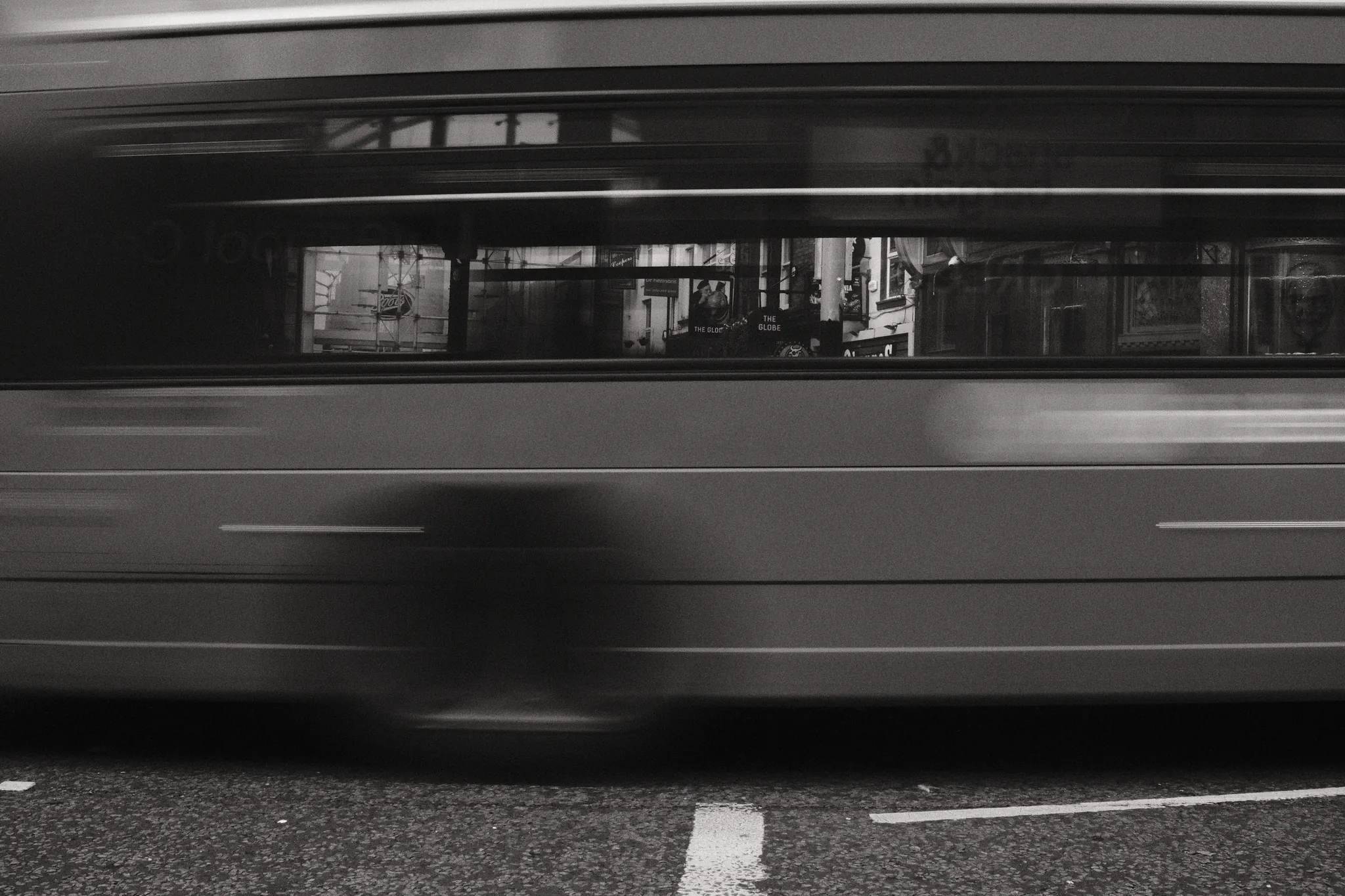 A passing bus becomes a band of motion across the street.